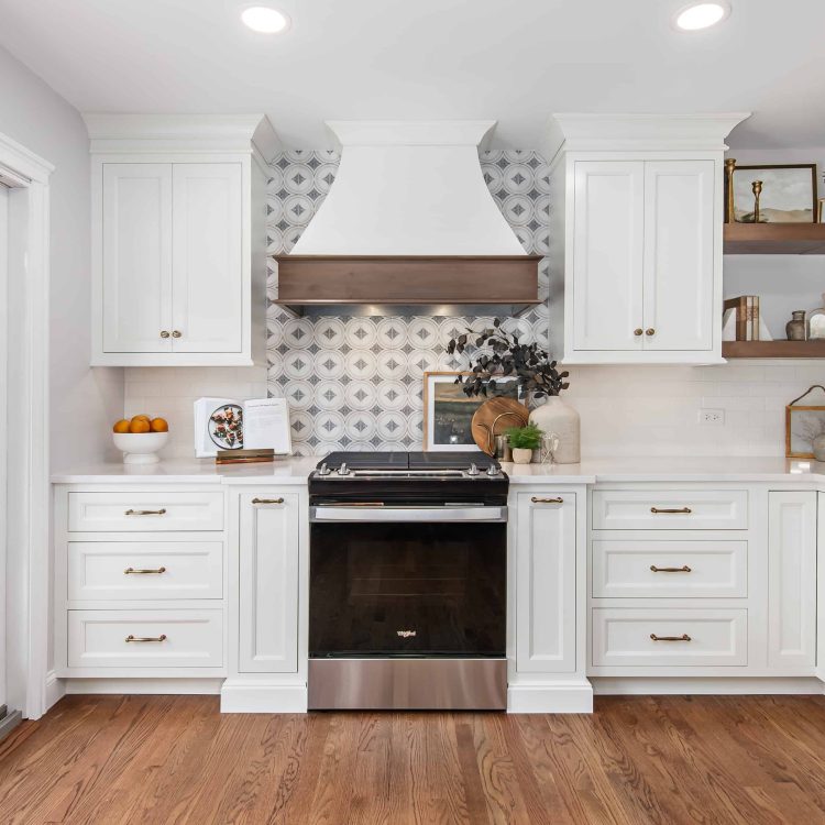 Range with custom wood hood used during kitchen renovation in Riverwoods 