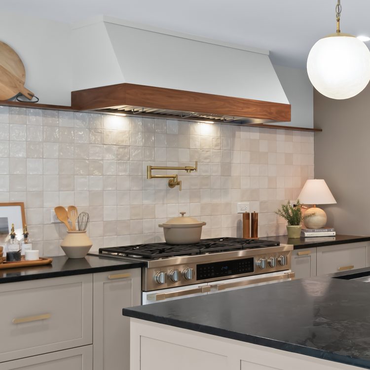 Modern kitchen remodel in Kildeer showcasing custom hood, soap stone counters and large island.