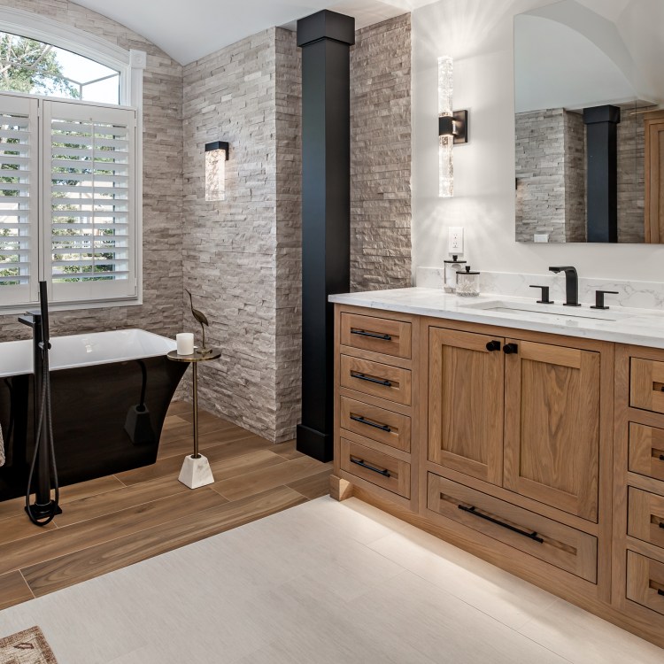 Luxury master bathroom remodel in Elk Grove Village featuring an Oak vanity and free standing tub.